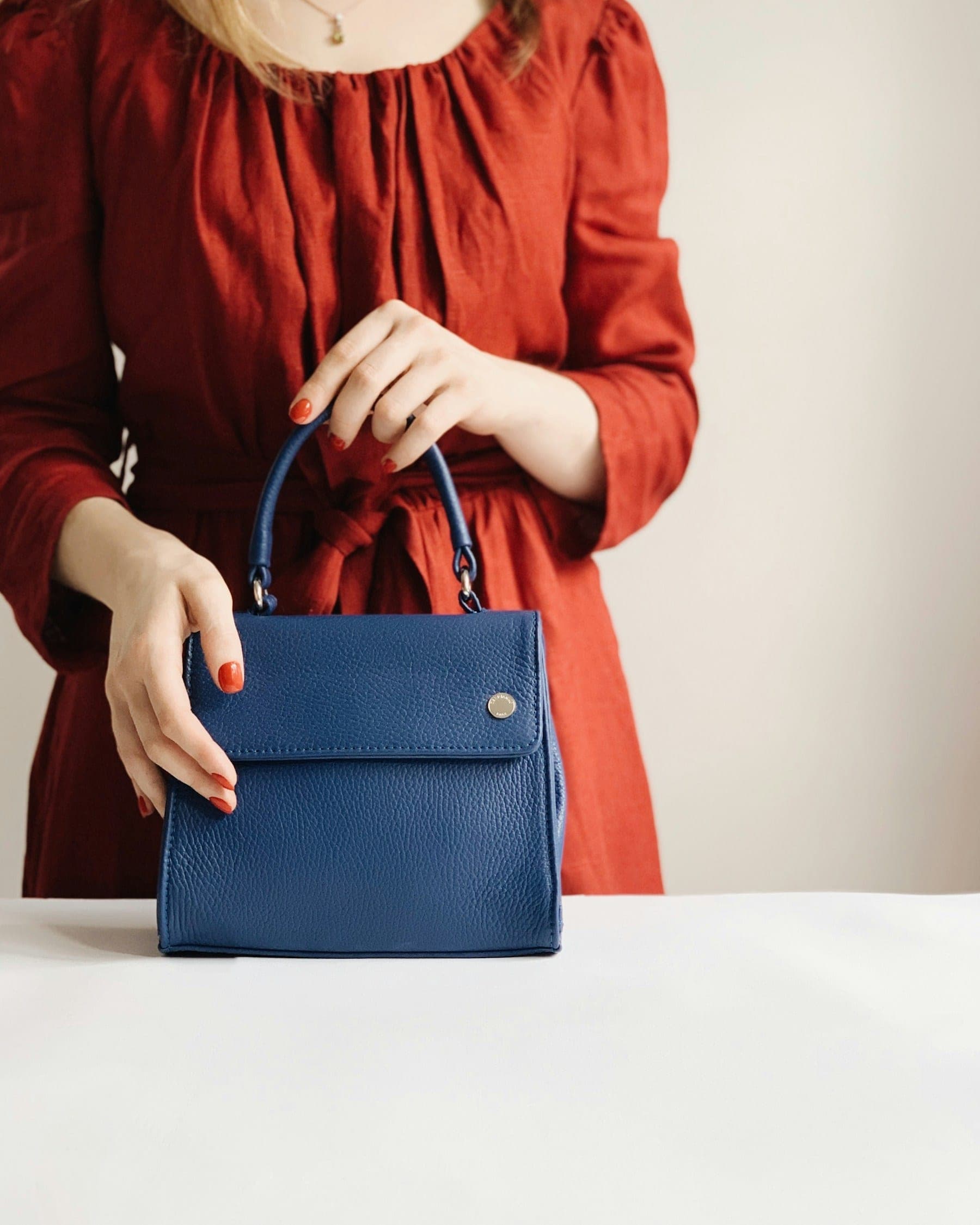 Woman carrying a structured leather handbag